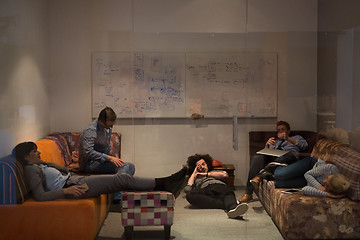 Image showing software developers sleeping on sofa in creative startup office