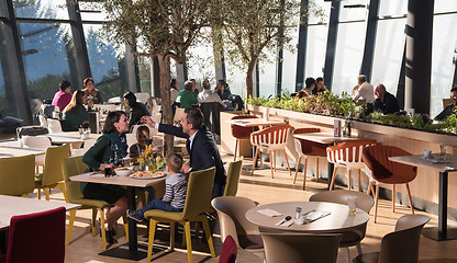 Image showing Young parents enjoying lunch time with their children