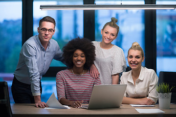 Image showing Multiethnic startup business team in night office