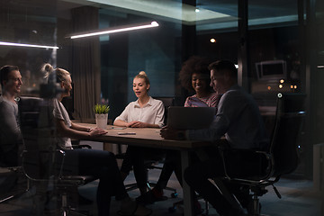 Image showing Multiethnic startup business team in night office