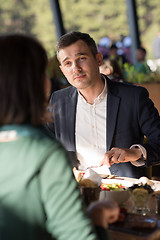 Image showing Closeup shot of young woman and man having meal.