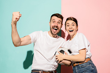 Image showing The young fans celebrating on blue and pink trendy colors.