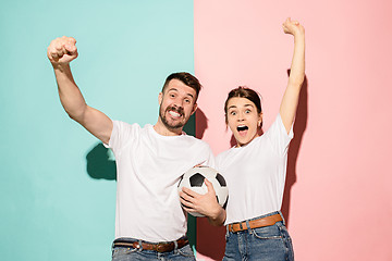 Image showing The young fans celebrating on blue and pink trendy colors.