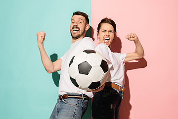 Image showing The young fans celebrating on blue and pink trendy colors.