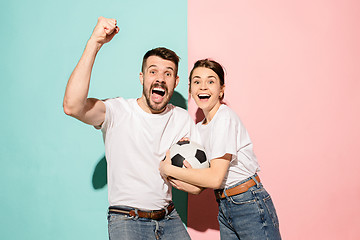 Image showing The young fans celebrating on blue and pink trendy colors.