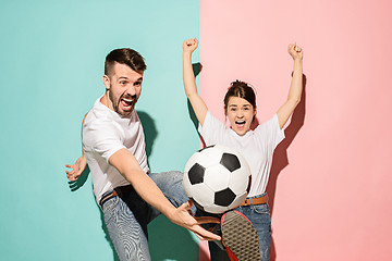 Image showing The young fans celebrating on blue and pink trendy colors.