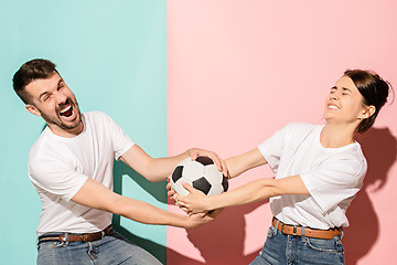 Image showing The unhappy and angry fans on colored blue and pink background.