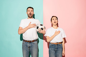 Image showing The young fans singing national anthem on blue and pink trendy colors.