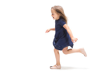 Image showing Smiling cute toddler girl three years running over white background