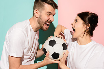 Image showing The unhappy and angry fans on colored blue and pink background.