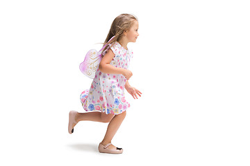 Image showing Smiling cute toddler girl three years running over white background