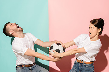 Image showing The unhappy and angry fans on colored blue and pink background.