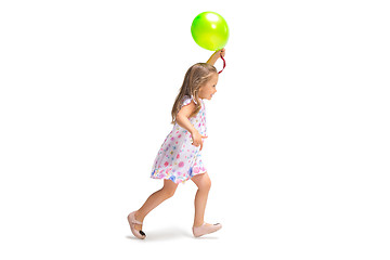 Image showing Smiling cute toddler girl three years running over white background