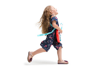 Image showing Smiling cute toddler girl three years running over white background