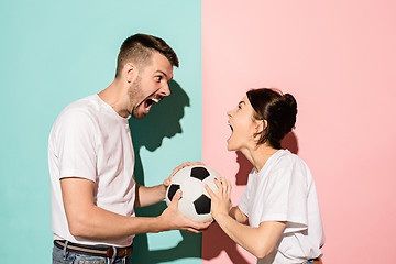 Image showing The unhappy and angry fans on colored blue and pink background.