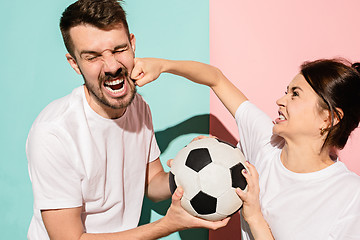 Image showing The unhappy and angry fans on colored blue and pink background.