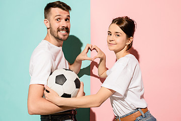 Image showing The young fans celebrating on blue and pink trendy colors.