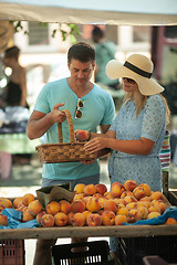 Image showing A couple getting peaches at the market