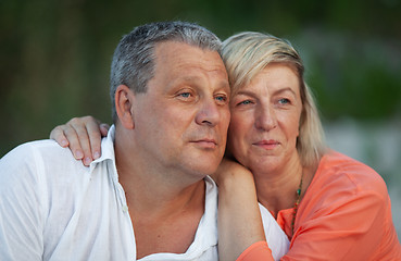 Image showing A portrait of a smiling middle aged couple looking into the distance