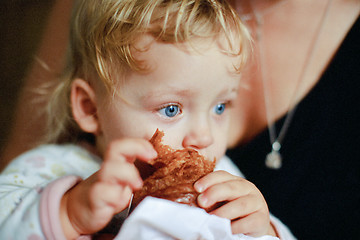 Image showing Blue eyes of a croissant eater