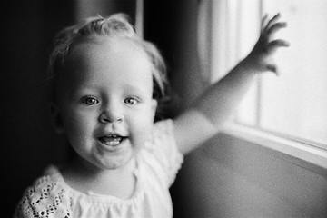 Image showing Portrait of happy one year old girl in black and white