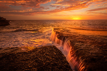 Image showing Tidal waterfalls coloured by summer sunrise scenic landscape Australia