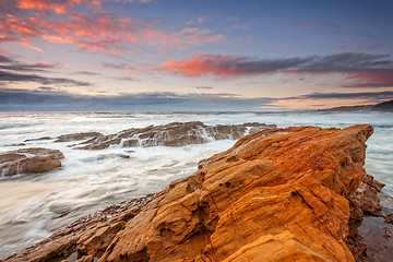 Image showing An emotional tempestuous ocean surges inland and cascades over r