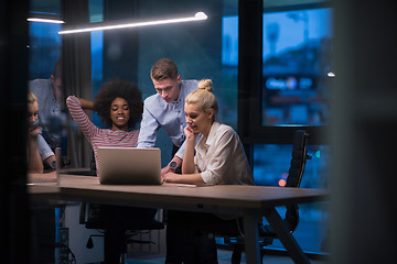 Image showing Multiethnic startup business team in night office