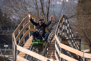 Image showing father and son enjoys driving on alpine coaster