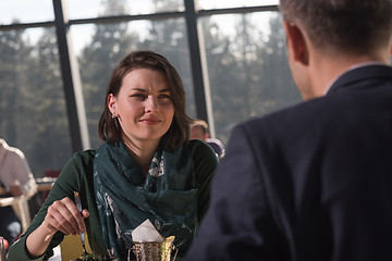 Image showing Closeup shot of young woman and man having meal.