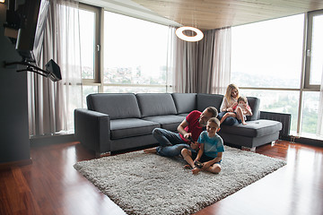 Image showing Happy family playing a video game