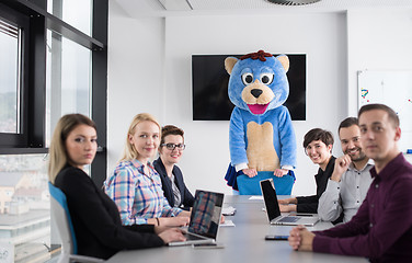 Image showing boss dresed as bear having fun with business people in trendy of