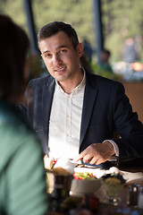 Image showing Closeup shot of young woman and man having meal.