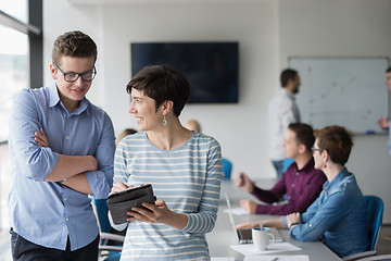 Image showing Two Business People Working With Tablet in office