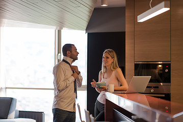 Image showing A young couple is preparing for a job and using a laptop