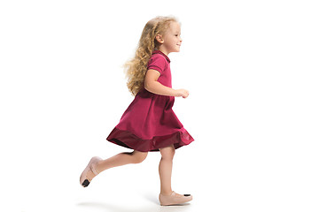 Image showing Smiling cute toddler girl three years running over white background