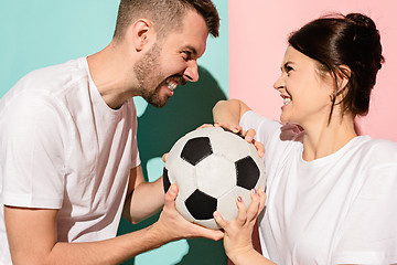 Image showing The unhappy and angry fans on colored blue and pink background.