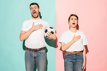 Image showing The young fans singing national anthem on blue and pink trendy colors.