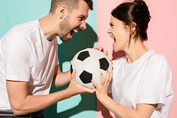 Image showing The unhappy and angry fans on colored blue and pink background.