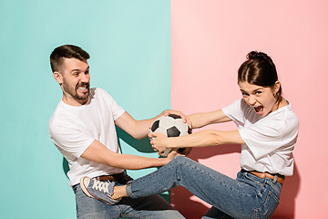 Image showing The unhappy and angry fans on colored blue and pink background.