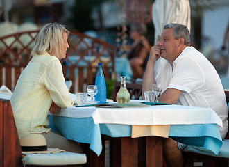 Image showing Loving mature couple having dinner in outdoor cafe