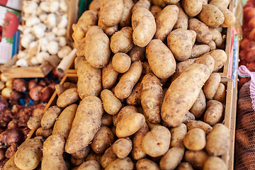 Image showing A closeup of potatoes in wooden boxes