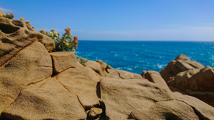 Image showing Defocused. Beautiful azure sea and the rocky beach