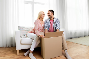 Image showing happy couple with open parcel box at home