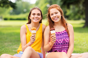 Image showing teenage girls eating ice cream at picnic in park