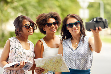 Image showing women with map travelling and recording video blog