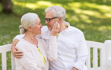 Image showing happy senior couple sitting on bench at park