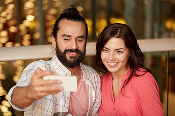 Image showing couple taking selfie by smartphone at restaurant