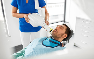 Image showing dentist making dental x-ray of patient teeth