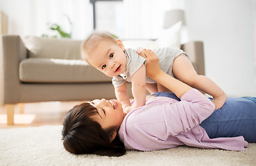 Image showing happy young mother with little baby at home